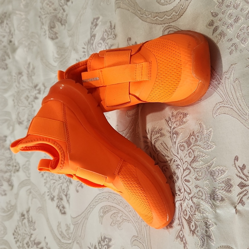 In great condition. Neon orange Skechers shoes (size 2).